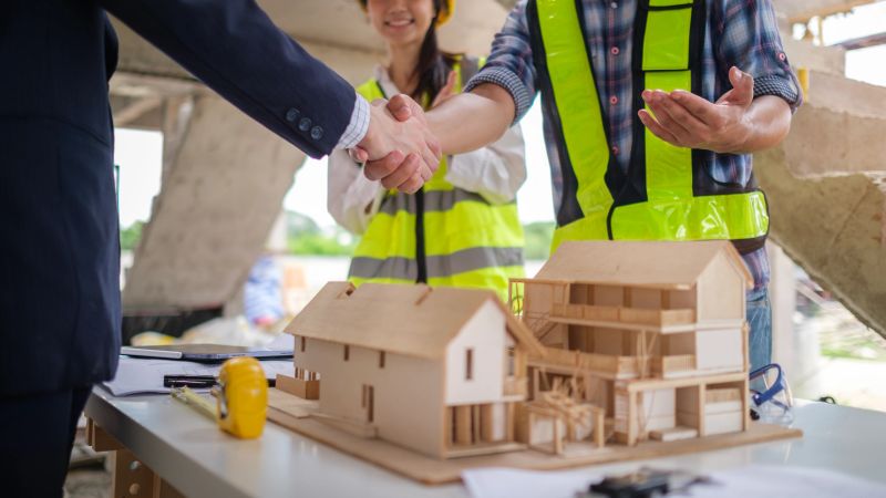 Advisors reviewing a client's budget and property goals